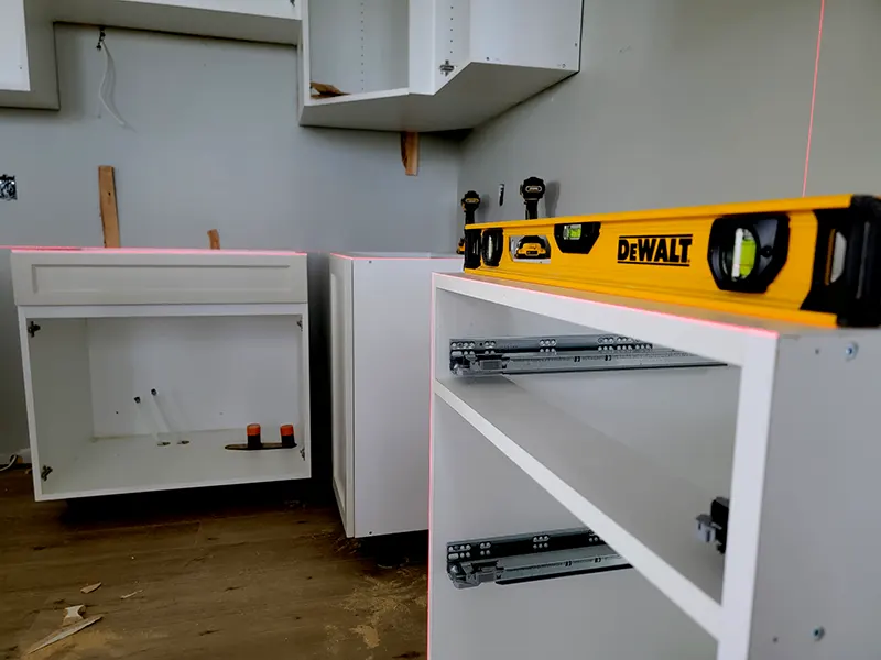 Cabinet installation using precision laser alignment